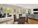 Bright dining area connects to a living room with a fireplace and offers views of an outdoor deck through large windows at 70 Williamsburg Ct, Zionsville, IN 46077