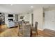 Open concept living space with a dining table and woven chairs next to a fireplace and built-in bookshelves at 70 Williamsburg Ct, Zionsville, IN 46077