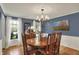 Charming dining room with wainscoting, hardwood floors, and ample natural light at 70 Williamsburg Ct, Zionsville, IN 46077
