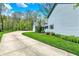 Long driveway leads to a home with well-manicured lawn and a detached garage at 70 Williamsburg Ct, Zionsville, IN 46077