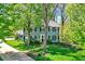 Charming two-story home with a lush green lawn and mature trees at 70 Williamsburg Ct, Zionsville, IN 46077