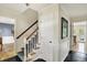 Open foyer with staircase, white wainscoting, and views to other rooms at 70 Williamsburg Ct, Zionsville, IN 46077