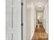 Hallway with hardwood floors and recessed lighting leading to rooms with hardwood and carpet at 70 Williamsburg Ct, Zionsville, IN 46077