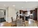 Eat-in kitchen features wood floors, stainless appliances, a large island, and doorway access to other rooms at 70 Williamsburg Ct, Zionsville, IN 46077