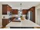 Well-lit kitchen boasts stainless appliances, a large island with a white countertop, dark cabinets, plus wood cabinetry at 70 Williamsburg Ct, Zionsville, IN 46077