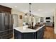 Spacious kitchen features a large island, stainless appliances, and flows into a living area with a fireplace at 70 Williamsburg Ct, Zionsville, IN 46077