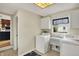 Well-lit laundry room with washer, dryer, cabinets, and view to the kitchen at 70 Williamsburg Ct, Zionsville, IN 46077