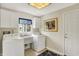 Bright laundry room features a window, washer, dryer, sink, and upper cabinets at 70 Williamsburg Ct, Zionsville, IN 46077
