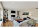 Bright living room features a fireplace, built-in shelves, hardwood floors, and an open floorplan at 70 Williamsburg Ct, Zionsville, IN 46077