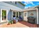 Outdoor patio area complete with brick flooring, garden, seating and a grill at 70 Williamsburg Ct, Zionsville, IN 46077