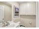 Updated powder room features white cabinets, white fixtures, neutral paint, and framed art at 70 Williamsburg Ct, Zionsville, IN 46077