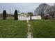 Detached one-car garage and shed in a spacious yard, perfect for storage and projects at 712 E Mckenzie Rd, Greenfield, IN 46140