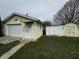 Detached one-car garage with additional storage sheds, offering ample space at 712 E Mckenzie Rd, Greenfield, IN 46140