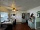 Kitchenette with laminate flooring, a small table, and light green cabinets at 712 E Mckenzie Rd, Greenfield, IN 46140