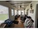 Enclosed sunroom with many windows, exercise equipment, and wood-look floors at 712 E Mckenzie Rd, Greenfield, IN 46140