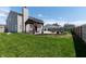 Spacious backyard with a gazebo-covered patio, fire pit, and lush green grass at 717 Driftwood Cir, Danville, IN 46122