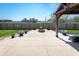 Backyard patio featuring a wooden pergola, brick fire pit, and an expansive green lawn at 717 Driftwood Cir, Danville, IN 46122