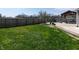 Lush green backyard with a large patio featuring a wooden gazebo and a brick firepit at 717 Driftwood Cir, Danville, IN 46122