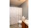 Cozy bathroom with modern shower head, marbled shower curtain, and wood-style flooring at 717 Driftwood Cir, Danville, IN 46122