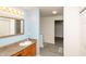 Light blue toned bathroom features a vanity and a walk-in closet at 717 Driftwood Cir, Danville, IN 46122
