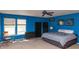 Blue bedroom featuring a bed, chair, and dark shelving at 717 Driftwood Cir, Danville, IN 46122