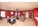 Bonus room with plush carpeting, ceiling fan, and comfortable recliner seating at 717 Driftwood Cir, Danville, IN 46122