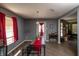 View of the dining room with wood floors and red curtains adjacent to the living room fireplace at 717 Driftwood Cir, Danville, IN 46122