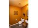Cozy half bathroom with warm colors, decorative fixtures, and modern vanity, perfect for guests at 717 Driftwood Cir, Danville, IN 46122