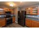 Well-equipped kitchen features sleek stainless steel appliances, classic wood cabinets, and stylish countertops at 717 Driftwood Cir, Danville, IN 46122