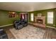 Spacious living room features a stone fireplace, accent rug and comfortable leather seating at 717 Driftwood Cir, Danville, IN 46122