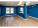 Bright living room with fresh paint, modern gray flooring, and ample natural light from the windows at 717 Driftwood Cir, Danville, IN 46122