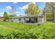 Well-maintained backyard with a covered deck, lush green lawn, and mature trees offering plenty of space at 7170 Janean Dr, Brownsburg, IN 46112