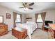 Comfortable bedroom with a ceiling fan, bed with white linens, and ample natural light at 7170 Janean Dr, Brownsburg, IN 46112