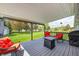 Relaxing covered deck featuring comfortable seating and an outdoor fire pit, perfect for entertaining at 7170 Janean Dr, Brownsburg, IN 46112