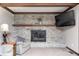 Close-up of the stone fireplace in the living room with a floating mantle at 7170 Janean Dr, Brownsburg, IN 46112