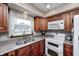 Spacious kitchen with granite countertops, stainless steel sink, and appliances at 7170 Janean Dr, Brownsburg, IN 46112