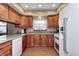Well-lit kitchen with stained cabinets, modern appliances, and ample counter space at 7170 Janean Dr, Brownsburg, IN 46112