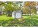 A well-maintained shed with double doors and a ramp provides extra storage space in the lush backyard at 7170 Janean Dr, Brownsburg, IN 46112