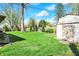 Spacious backyard with green lawn, mature trees, and a shed for extra storage at 731 Oak Dr, Greenwood, IN 46142