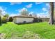 Large backyard featuring a green lawn, mature trees, and a patio, perfect for outdoor living at 731 Oak Dr, Greenwood, IN 46142