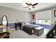 Comfortable bedroom with carpet, ceiling fan, two-tone paint, and an antique trunk at the end of the bed at 731 Oak Dr, Greenwood, IN 46142