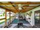 Inviting covered patio with ceiling fans, an outdoor table, and a foosball table for entertainment at 731 Oak Dr, Greenwood, IN 46142