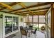Enclosed patio with tile floors, bright natural light, and comfortable outdoor seating arrangements at 731 Oak Dr, Greenwood, IN 46142