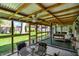 Relaxing covered patio with outdoor seating, a foosball table, and a view of the backyard at 731 Oak Dr, Greenwood, IN 46142