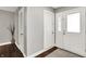 The entryway has gray walls, dark wood floors, white doors, and a decorative vase with branches at 731 Oak Dr, Greenwood, IN 46142