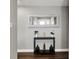Entryway with gray walls, wood floors, decorative vases and a black table with a white-framed mirror above it at 731 Oak Dr, Greenwood, IN 46142
