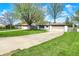 Charming single-story home features a long driveway and well-manicured lawn with mature trees and a two car garage at 731 Oak Dr, Greenwood, IN 46142