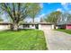 Attractive one-story home with a well-kept lawn, an attached two-car garage, and mature trees providing shade at 731 Oak Dr, Greenwood, IN 46142