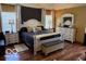 Comfortable main bedroom with elegant furnishings, including a dresser, nightstands, and a luxurious bed at 7594 W Williamswood Dr, New Palestine, IN 46163
