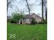 Exterior view of the home's backyard showcasing a garden and an arbor, perfect for outdoor enjoyment at 7594 W Williamswood Dr, New Palestine, IN 46163